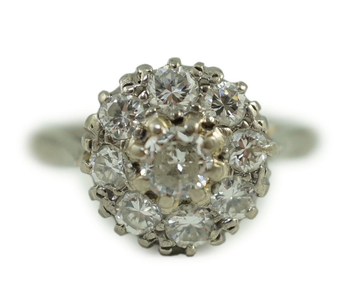 An 18ct white gold and nine stone diamond flower head cluster ring